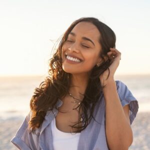 Carefree beautiful latin woman relaxing on beach